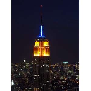 Top of the Empire State Building Illuminated at Night Above New York 