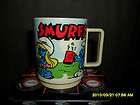 1980 PEYO KIDS DRINKING CUP WITH CARTOON PICTURES OF THE SMURFS