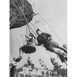 Off Duty Soviet Soldier Amusing Himself on Flying Swing at Parter Park 