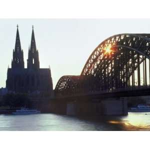 Arched Bridge with Ornate Twin Church Spires in City Photographic 