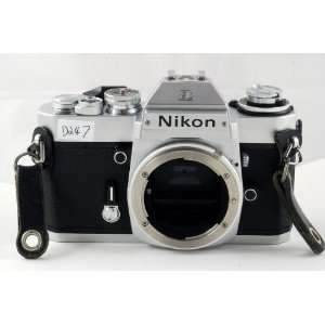   SLR film camera by Nikon; chrome body, lens not included Camera