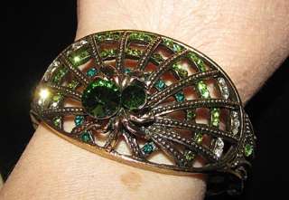  in the shape of a spider web with a large green rhinestone spider 