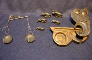 Opium Scale and Weights. Carved wooden holder of the scale has poppies 
