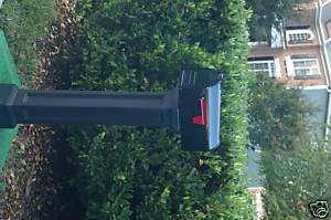 Black pedestal mailbox with black mailbox  