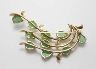 This is a lovely brooch in silver with a gold gilt wash with jade 