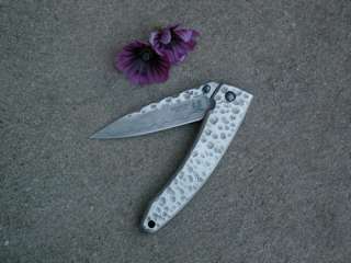 closed. 3 1/4 VG 10 damascus steel blade with dual thumb studs 
